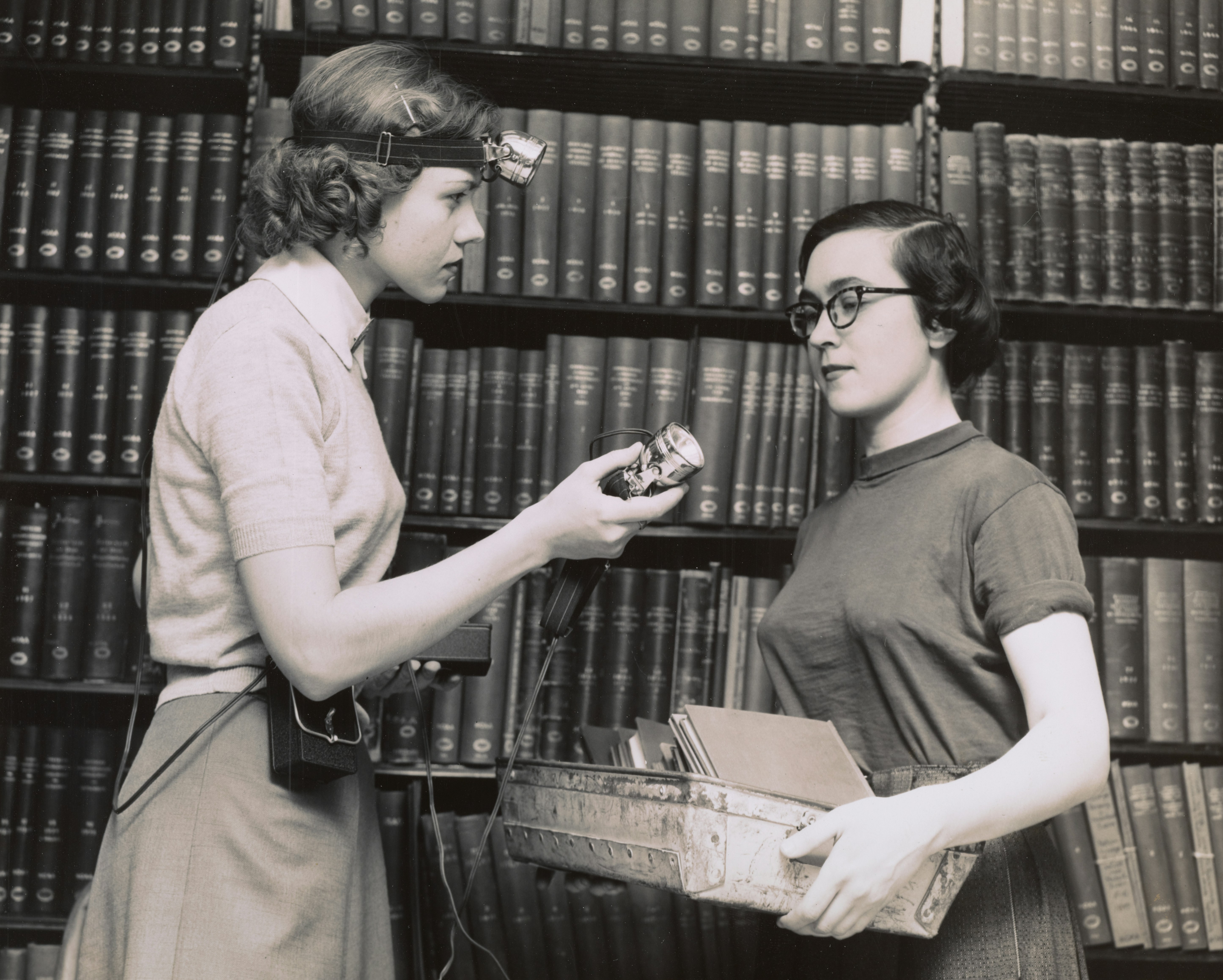A librarian assists a patron.
